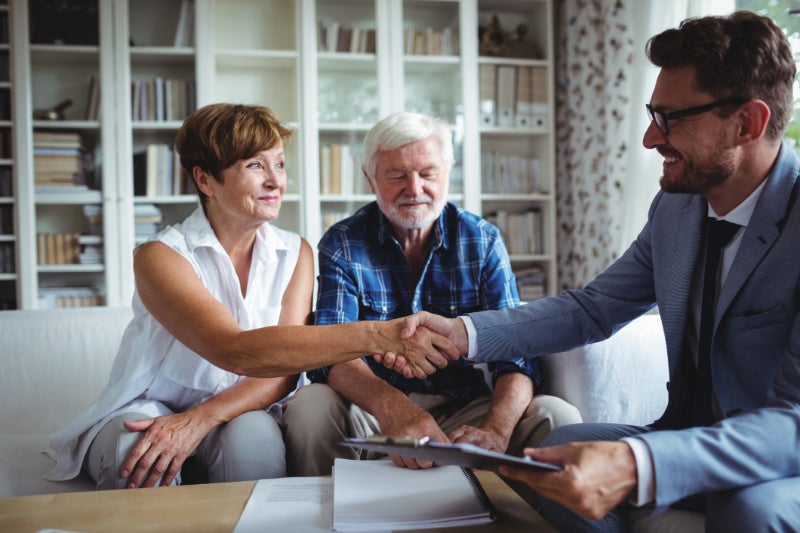 Mature man and woman meeting with insurance broker