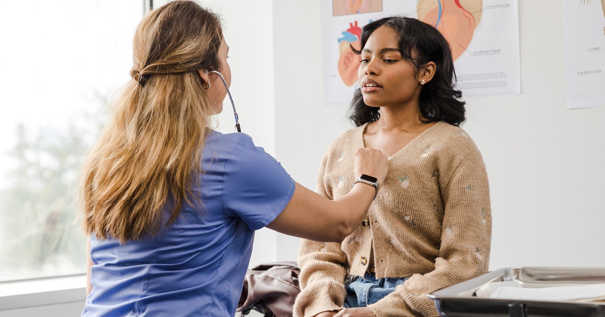 doctor listening to women's chest