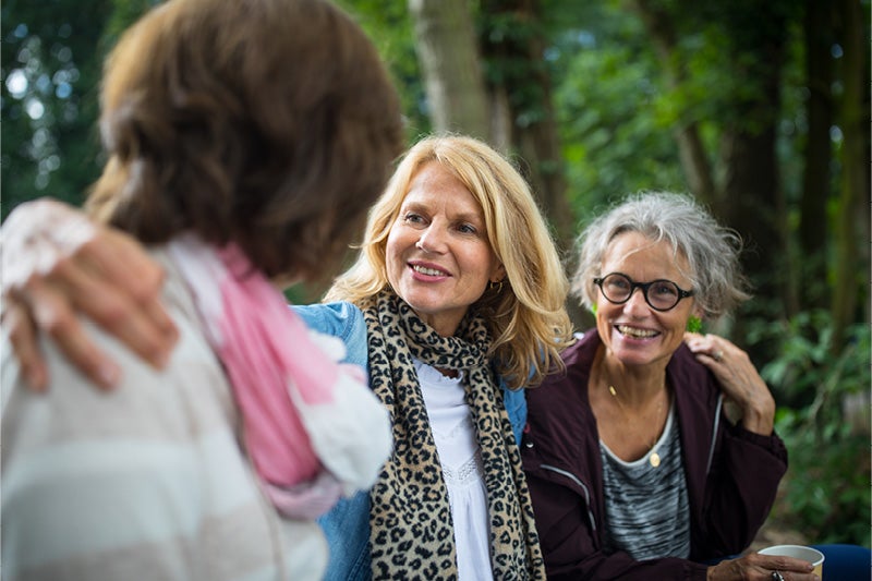 Group of women smiling at one another