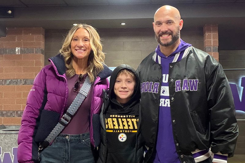 Drew Strube standing with his family