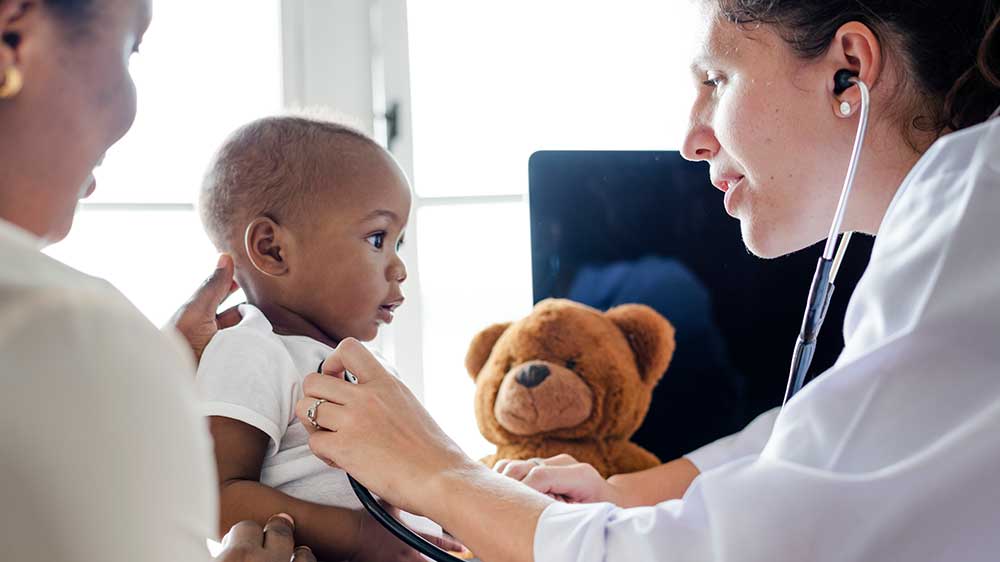 doctor listening to babys heart