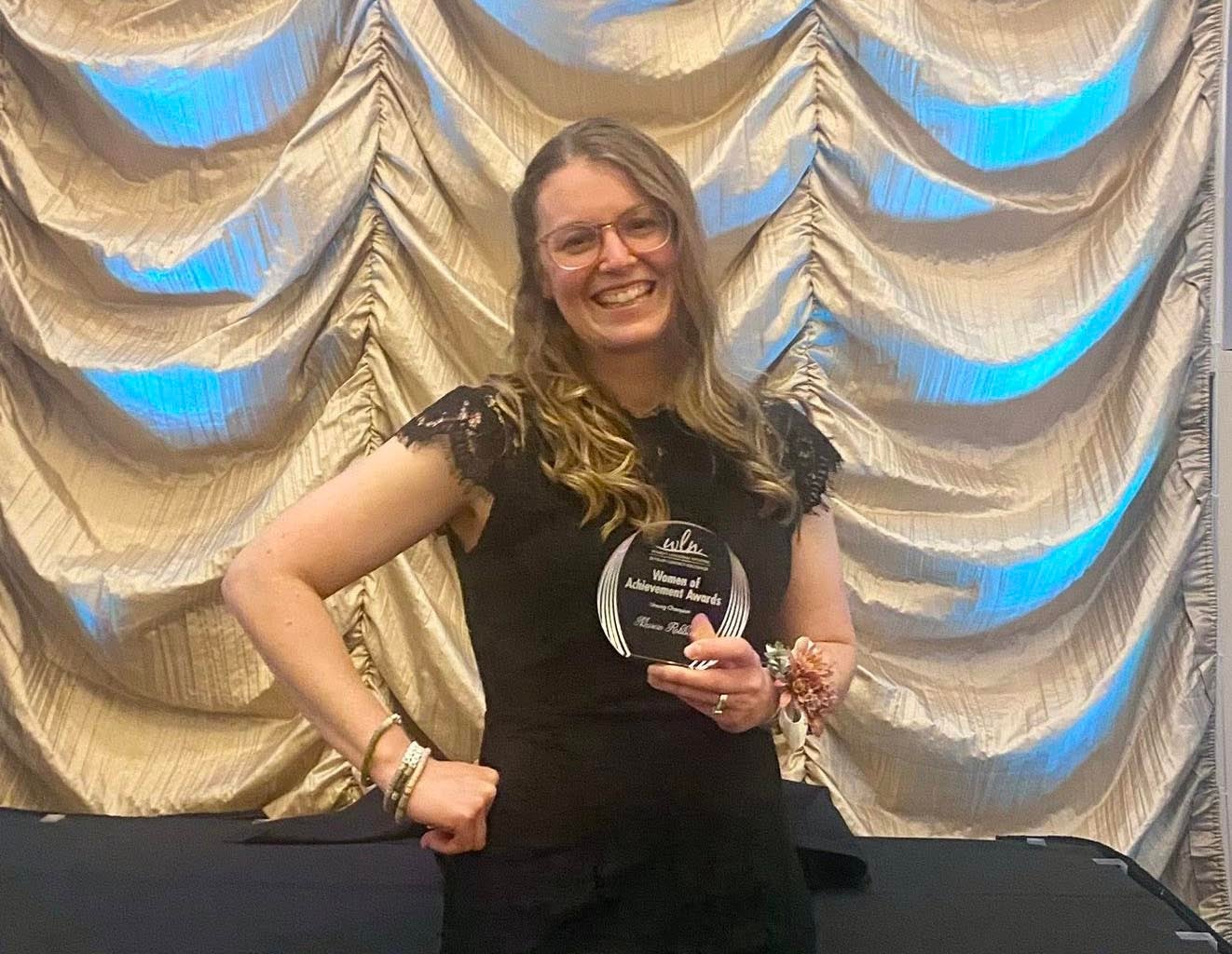 Marcie Robbins poses for a photo after receiving the Women of Achievement Award.