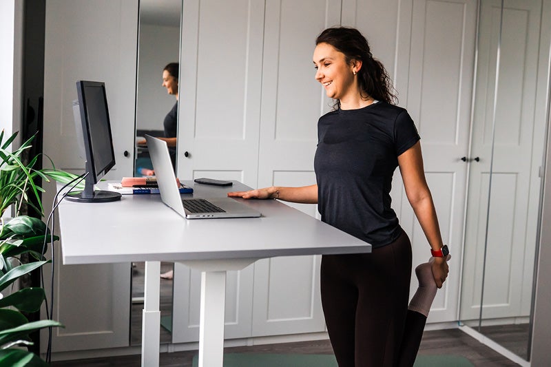 Woman stretching at her desk